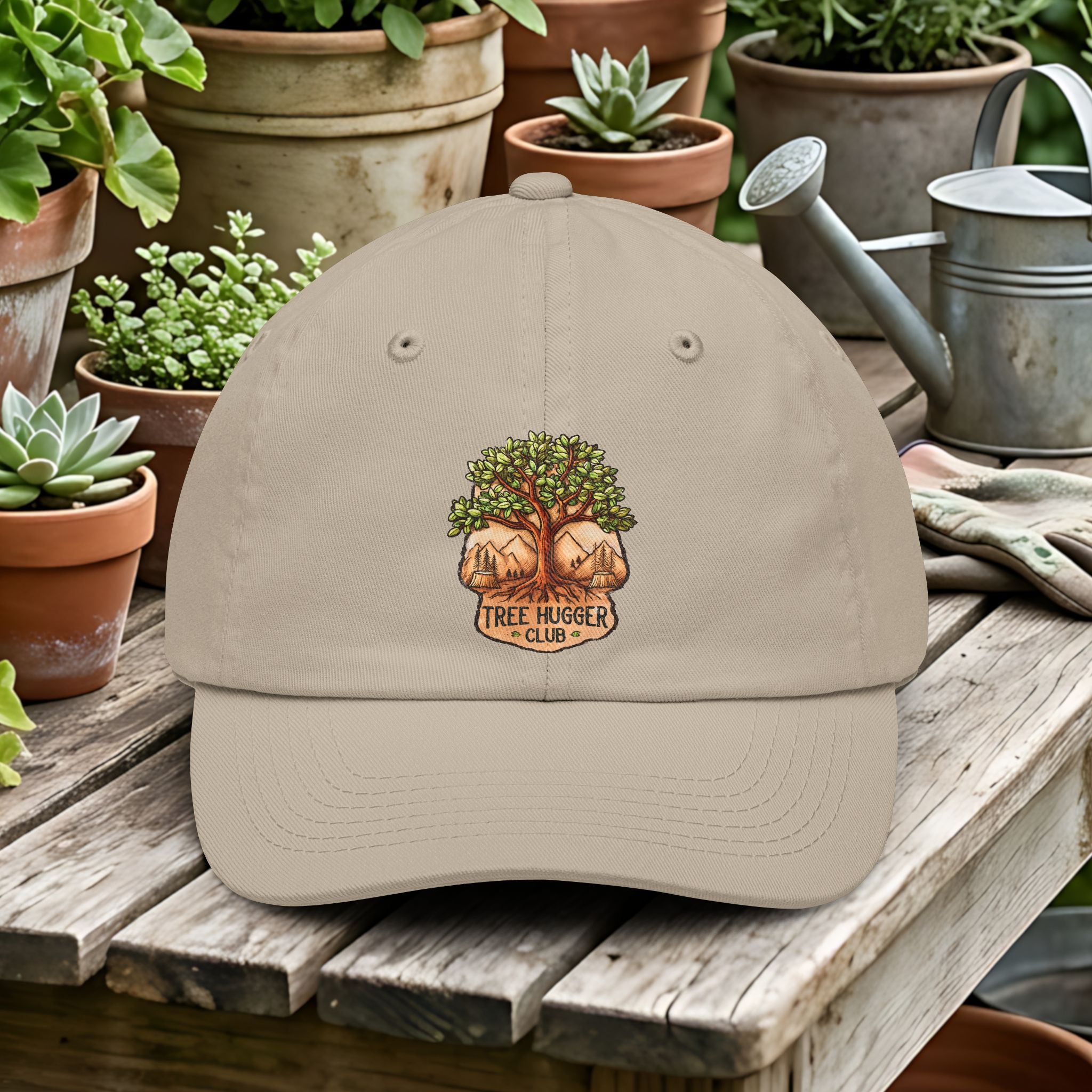 Beige cap with 'Tree Hugger Club' logo on a wooden table with potted plants and gardening tools.