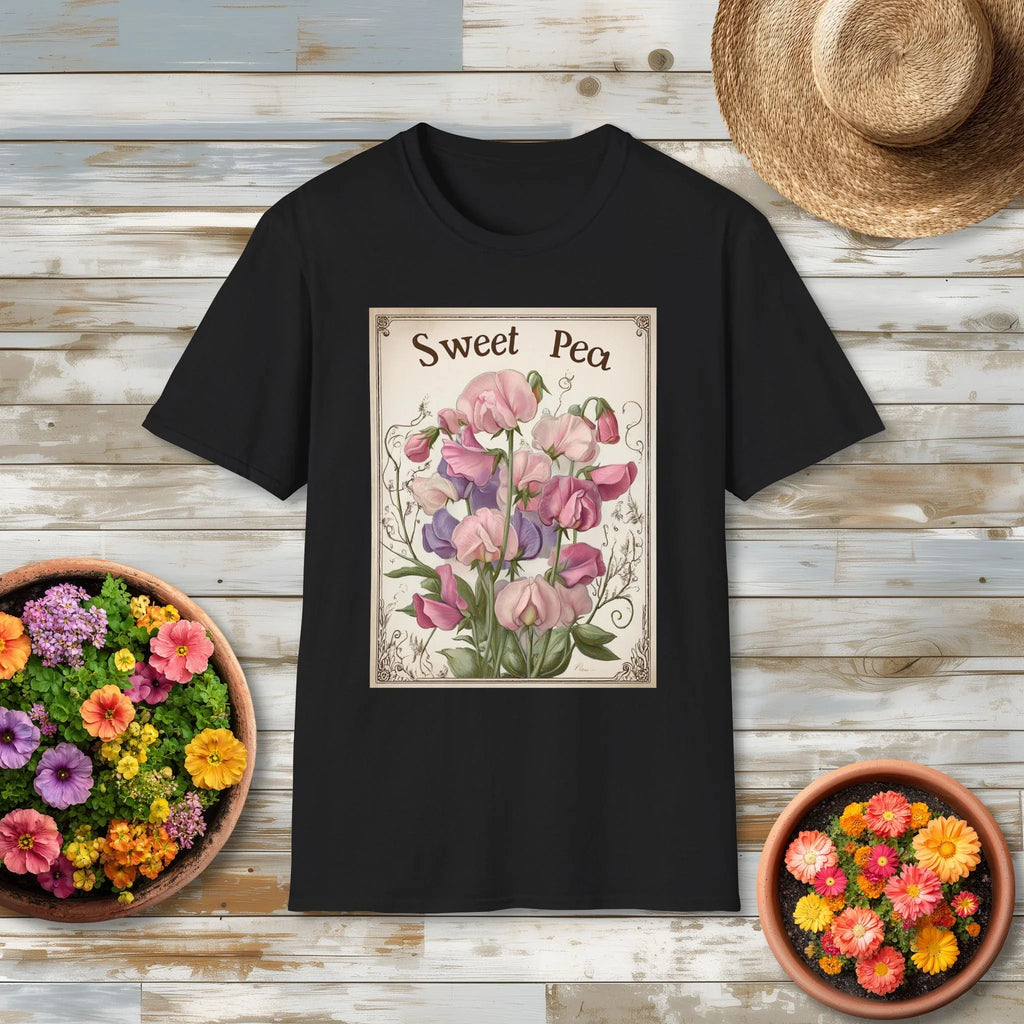 Black t-shirt with 'Sweet Pea' floral seed packet design on a wooden surface with flower pots and a straw hat.